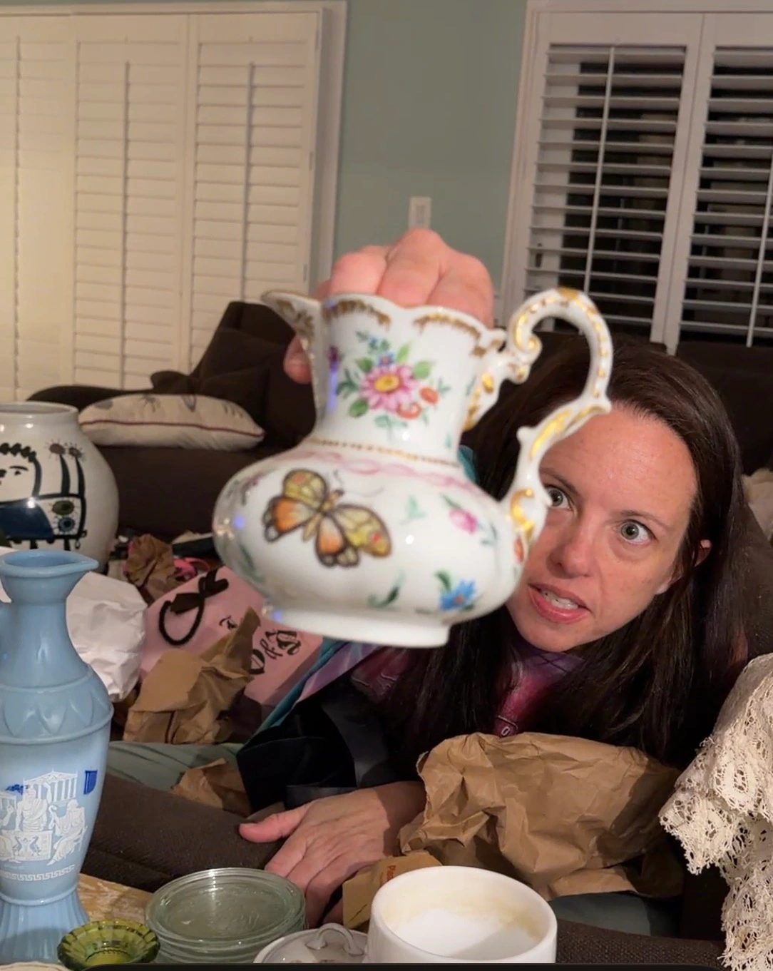 Gwen showcasing a hand-painted china pitcher