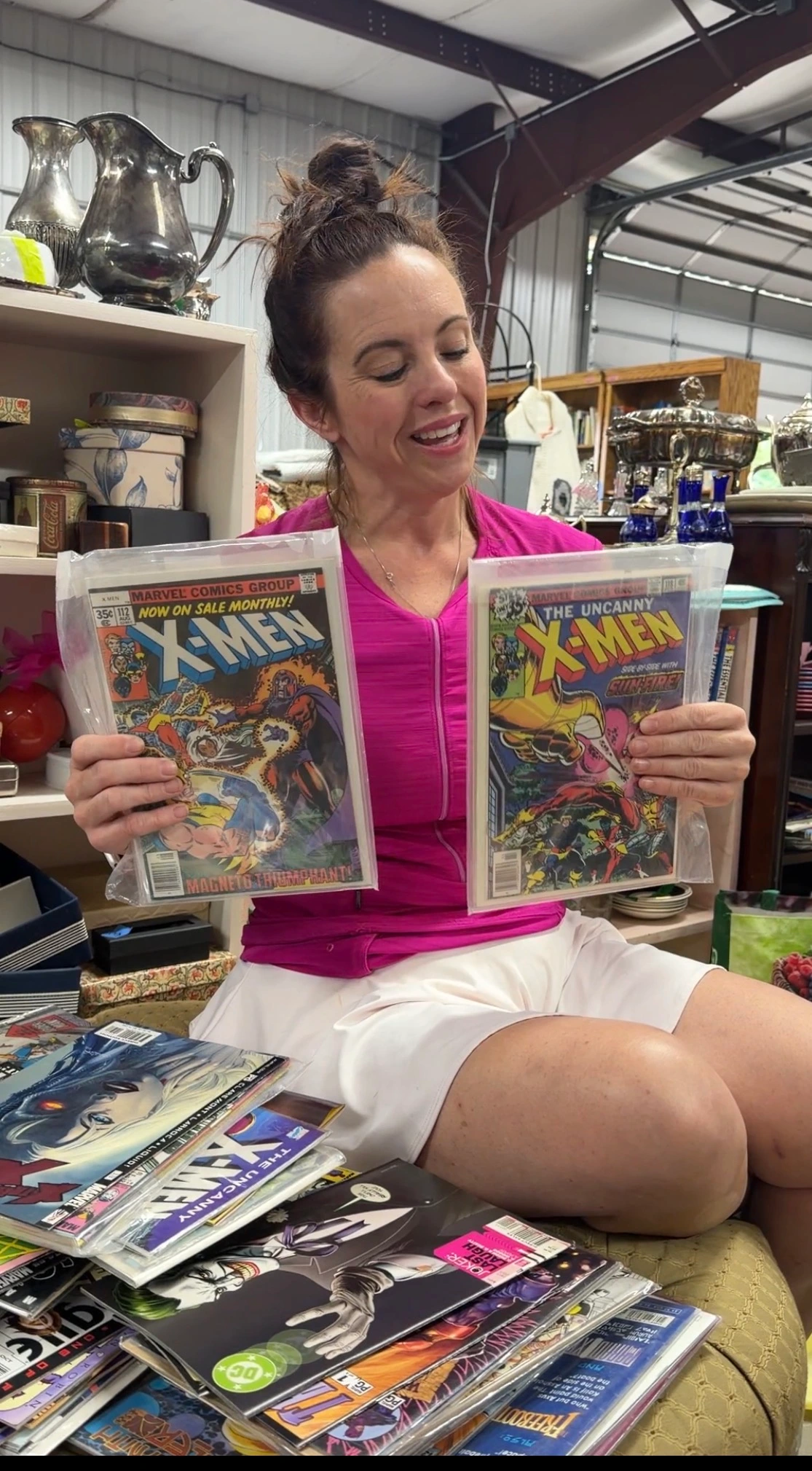Gwen showing vintage X-Men comic books on camera