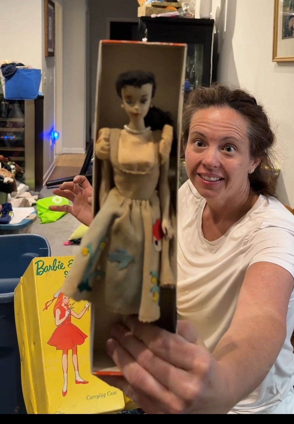 Gwen holding a vintage doll from a client's collection